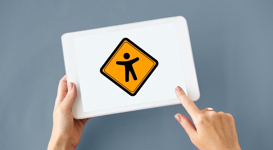 Two hands holding a tablet, the tablet shows a big icon with a stick figure symbolizing digital accessibility